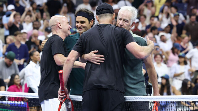 NEW YORK, NEW YORK - AUGUST 25: Roger Federer of Switzerland and John McEnroe of the United States embrace Andy Roddick of the United States and Andre Agassi of the United States after the exhibition doubles match during Fan Week at the USTA Billie Jean King National Tennis Center on August 25, 2026 in the Flushing neighborhood of the Queens borough of New York City.