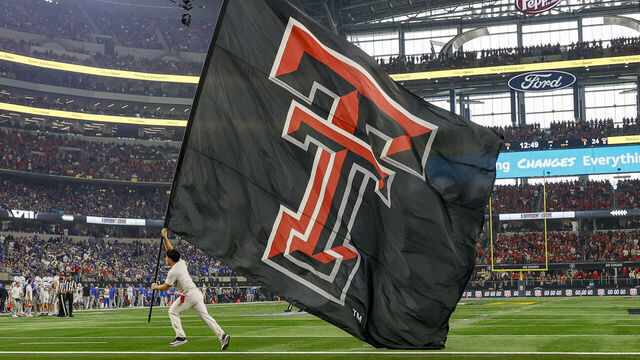 ARLINGTON, TX - DECEMBER 06: A flag runner runs by with a Texas Tech Red Raiders flag during the Edwards Jones Big 12 Championship game between the Texas Tech Red Raiders and the BYU Cougars on December 06, 2025 at AT&T Stadium in Arlington, Texas.