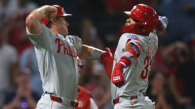 ANAHEIM, CALIFORNIA - AUGUST 28: Edmundo Sosa #33 of the Philadelphia Phillies celebrates a grand slam home run with J.T. Realmuto #10, to take a 5-3 lead over the Los Angeles Angels, during the ninth inning at Angel Stadium of Anaheim on August 28, 2026 in Anaheim, California.