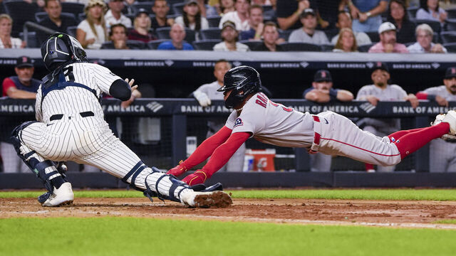 NEW YORK, NEW YORK - AUGUST 28: Center fielder Ceddanne Rafaela #3 of the Boston Red Sox is tagged out at home plate by catcher Austin Wells #28 of the New York Yankees in the seventh inning at Yankee Stadium on August 28, 2026 in New York City.