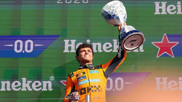 McLaren's British driver Lando Norris celebrates with the trophy during the awarding ceremony after the Formula 1 Dutch Grand Prix Race at Zandvoort Circuit, near Amsterdam, the Netherlands, Aug. 23, 2026.