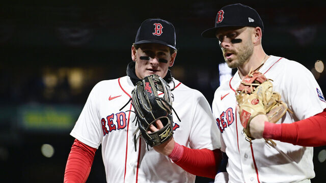 BOSTON, MASSACHUSETTS - APRIL 06: Roman Anthony #19 of the Boston Red Sox (left) and Trevor Story #10 of the Boston Red Sox jog back to the dugout between innings against the Milwaukee Brewers at Fenway Park on April 06, 2026 in Boston, Massachusetts.