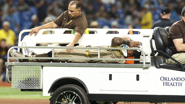 ST PETERSBURG, FLORIDA - AUGUST 29: Luis Rengifo #21 of the San Diego Padres has to be carried off the field in the bottom of the seventh inning against the Tampa Bay Rays at Tropicana Field on August 29, 2026 in St Petersburg, Florida.