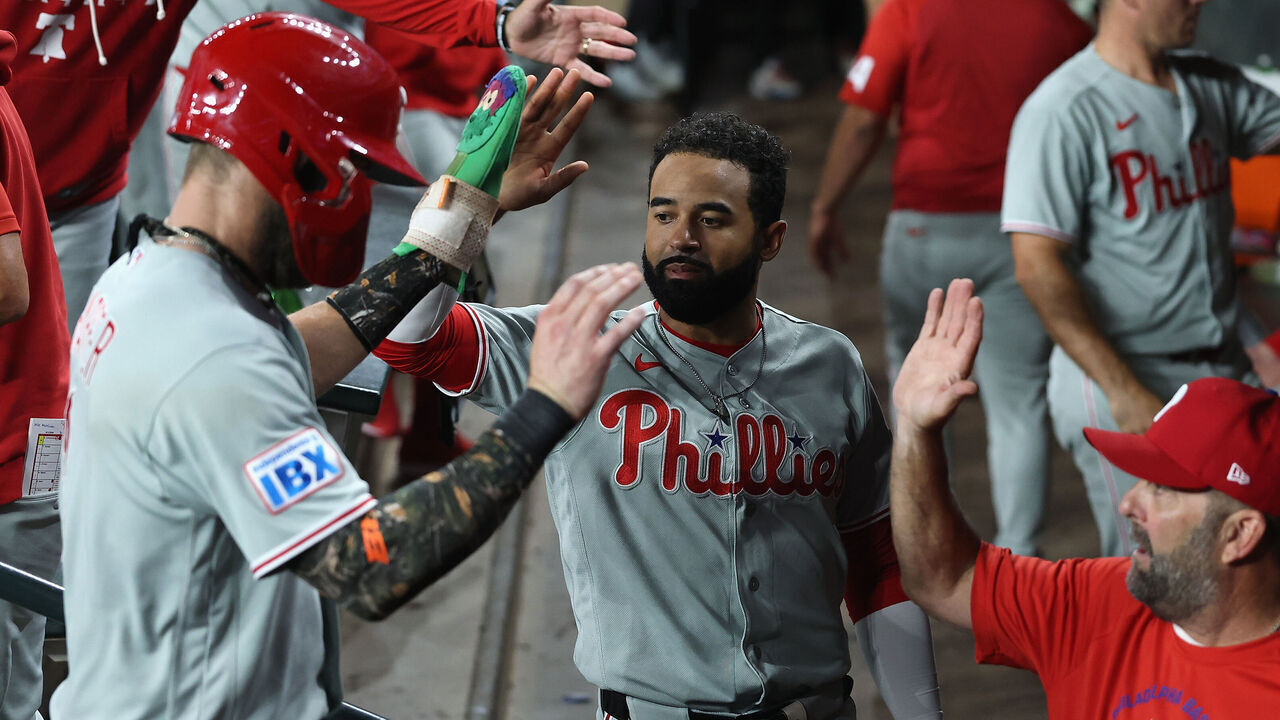 PHOENIX, ARIZONA - SEPTEMBER 01: Derek Hill #49 (C) of the Philadelphia Phillies high fives Bryce Harper #3 after Harper scored a run against the Arizona Diamondbacks during the fifth inning of the MLB game at Chase Field on September 01, 2026 in Phoenix, Arizona.
