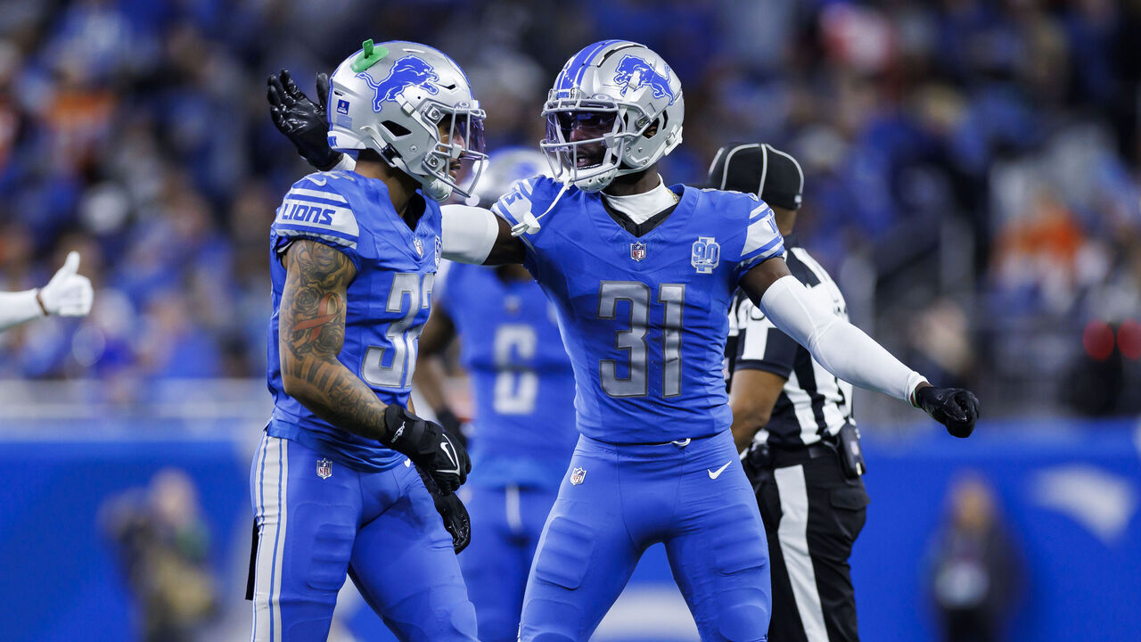 DETROIT, MICHIGAN - DECEMBER 16: Brian Branch #32 of the Detroit Lions celebrates Kerby Joseph #31 of the Detroit Lions after a play during an NFL football game against the Denver Broncos at Ford Field on December 16, 2023 in Detroit, Michigan.