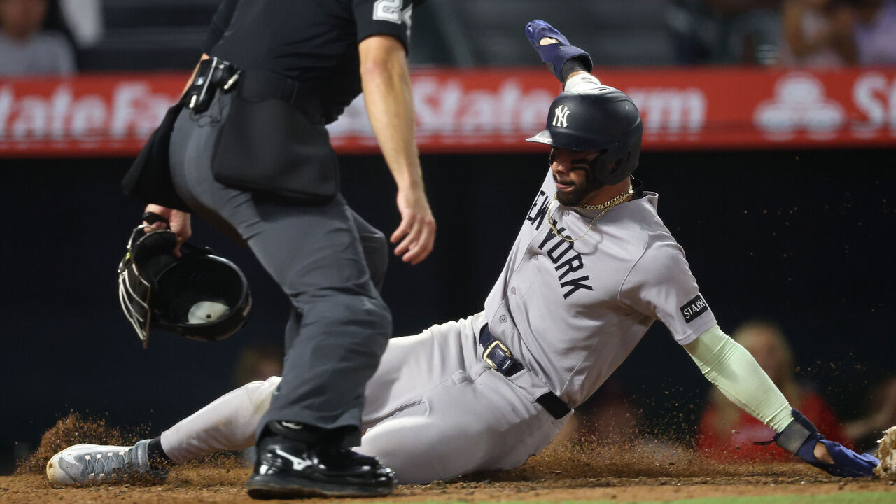 ANAHEIM, CALIFORNIA - SEPTEMBER 02: José Caballero #72 of the New York Yankees slides safely into home plate to score on a 2 RBI single by Austin Wells #28 against the Los Angeles Angels during the tenth inning at Angel Stadium of Anaheim on September 02, 2026 in Anaheim, California.
