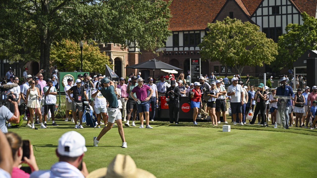 ATLANTA, GEORGIA - AUGUST 28: Garrett Clark of Good Good Golf plays a shot from the 10th hole tee as fans look on during the 2024 Creator Classic prior to the TOUR Championship, the final event of the FedExCup Playoffs, at East Lake Golf Club on August 28, 2024 in Atlanta, Georgia.