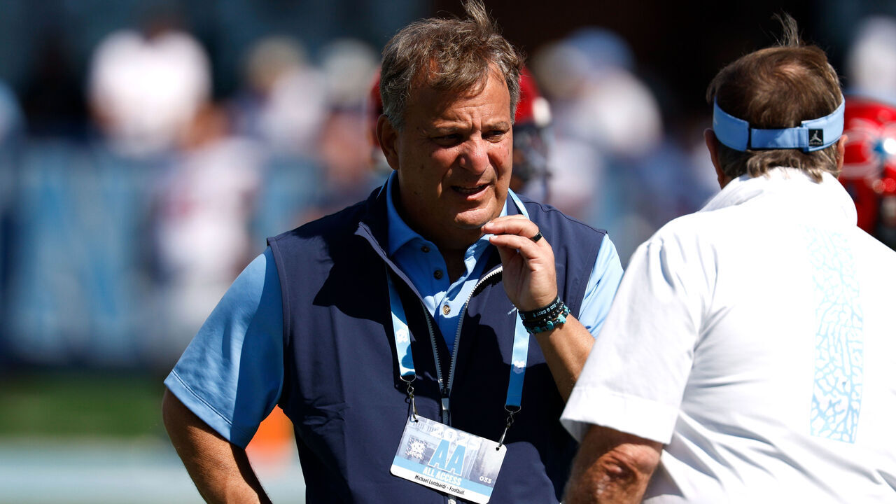 CHAPEL HILL, NORTH CAROLINA - SEPTEMBER 13: General manager Michael Lombardi talks with head coach Bill Belichick of the North Carolina Tar Heels prior to the game against the Richmond Spiders at Kenan Memorial Stadium on September 13, 2025 in Chapel Hill, North Carolina.