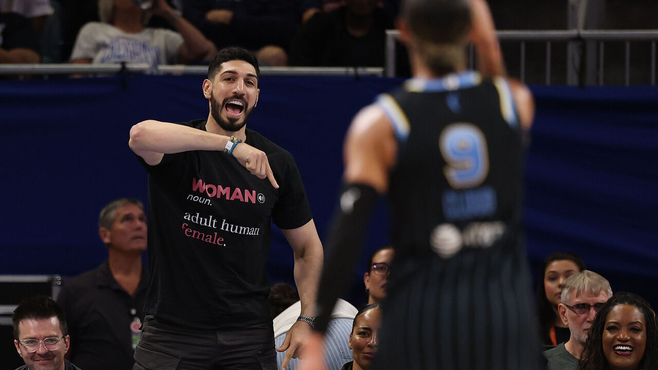 CHICAGO, ILLINOIS - AUGUST 23: Former basketball player Enes Kanter Freedom and Natasha Cloud #9 of the Chicago Sky engage in a verbal confrontation during the second half between the Chicago Sky and the Indiana Fever at Wintrust Arena on August 23, 2026 in Chicago, Illinois.