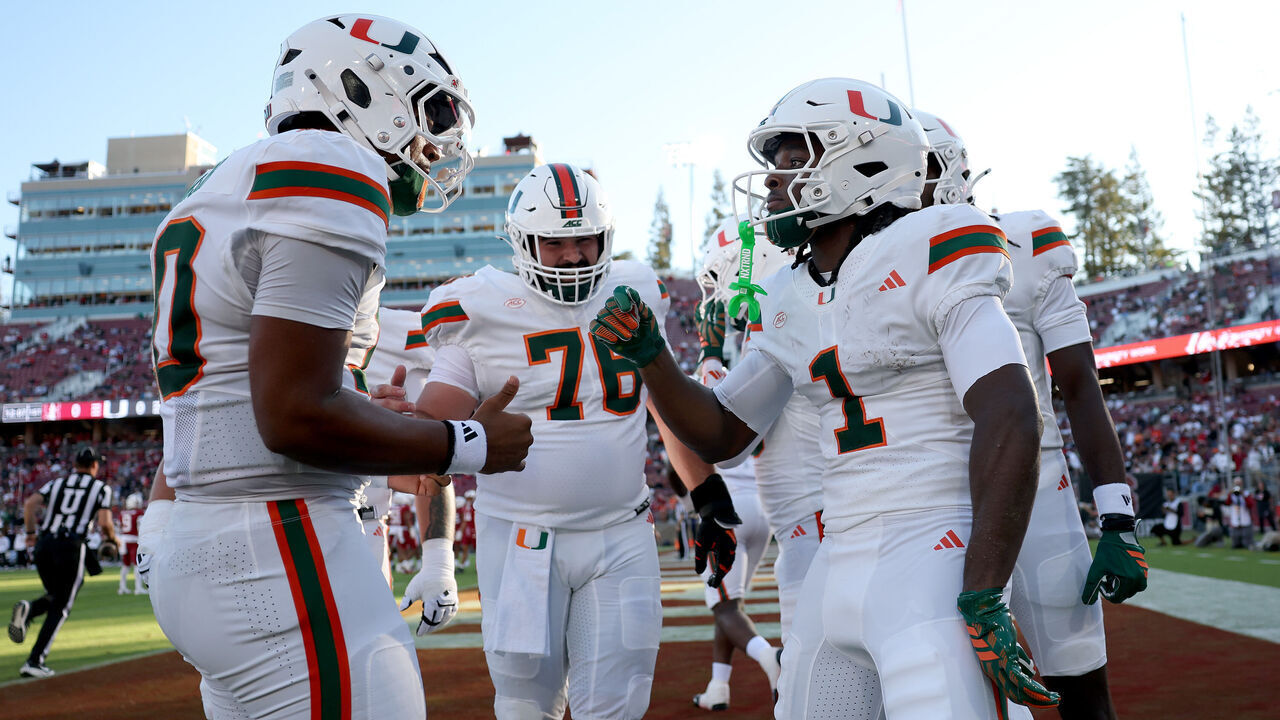 STANFORD, CALIFORNIA - SEPTEMBER 04: Malachi Toney #1 of the Miami (FL) Hurricanes is congratulated by Darian Mensah #10 after he scored his first touchdown against the Stanford Cardinal in the first half at Stanford Stadium on September 04, 2026 in Stanford, California.