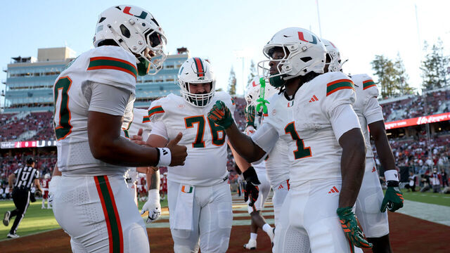 STANFORD, CALIFORNIA - SEPTEMBER 04: Malachi Toney #1 of the Miami (FL) Hurricanes is congratulated by Darian Mensah #10 after he scored his first touchdown against the Stanford Cardinal in the first half at Stanford Stadium on September 04, 2026 in Stanford, California.