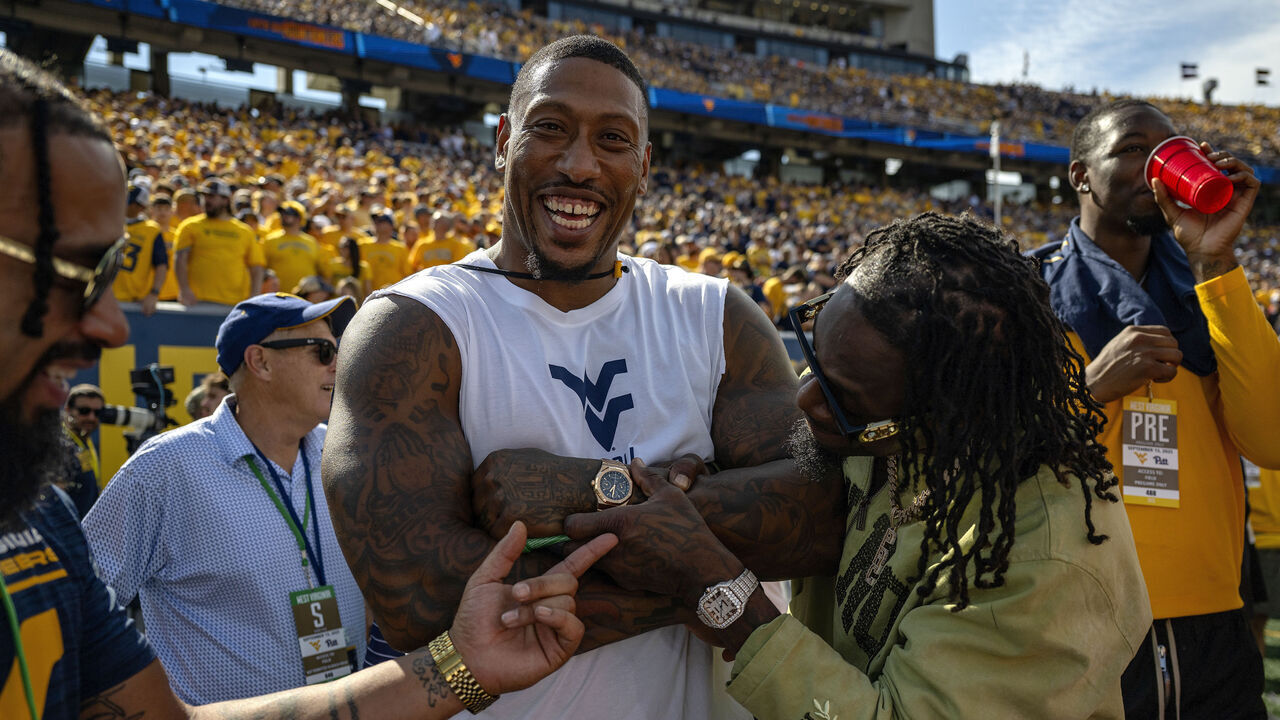 MORGANTOWN, WEST VIRGINIA - SEPTEMBER 13: West Virginia Mountaineers Alumni Vaughn Rivers, Pat White and Adam Jones on the field before a game against Pittsburgh Panthers during at Milan Puskar Stadium on September 13, 2025 in Morgantown, West Virginia.