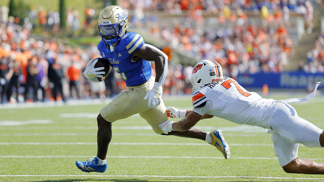 TULSA, OK - SEPTEMBER 05: Running back Damari Alston #6 of Tulsa Golden Hurricane scores on a one-yard touchdown run against safety Quinton Hammonds #7 of the Oklahoma State Cowboys only to have the play nullified by a holding call in the second quarter at Skelly Field at H. A. Chapman Stadium on September 5, 2026 in Tulsa, Oklahoma. Tulsa leads 10-3 at the half.