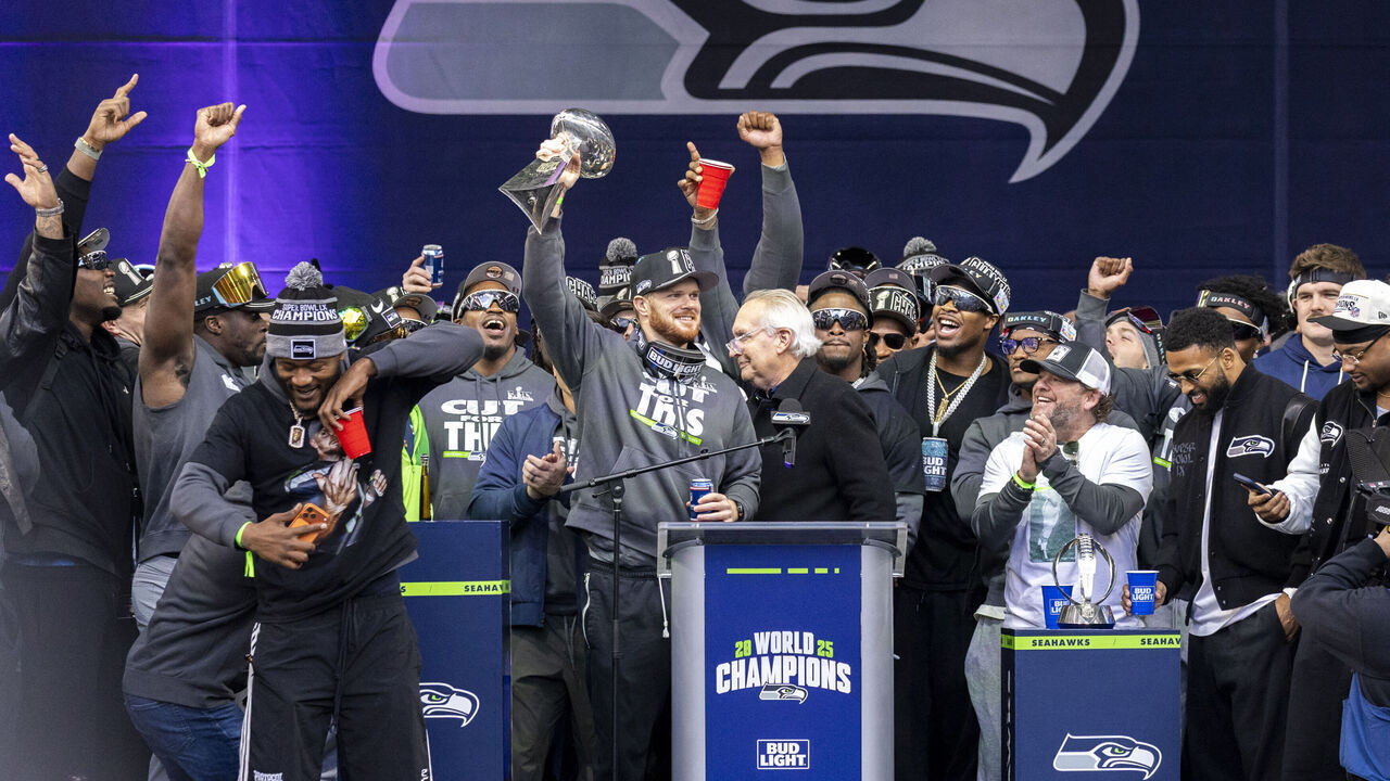 Sam Darnold of the Seattle Seahawks holds up the Vince Lombardi Trophy during a Super Bowl LX trophy celebration at Lumen Field in Seattle, Washington, on February 11, 2026.