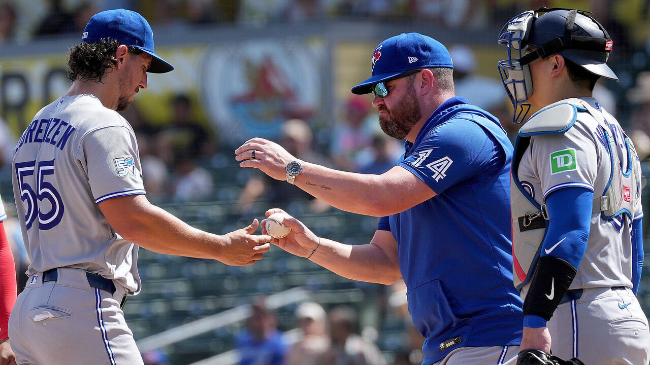 SACRAMENTO, CALIFORNIA - SEPTEMBER 09: Manager John Schneider #14 of the Toronto Blue Jays takes the ball from pitcher Michael Lorenzen #55 taking him out of the game against the Athletics in the bottom of the fourth inning at Sutter Health Park on September 09, 2026 in Sacramento, California.