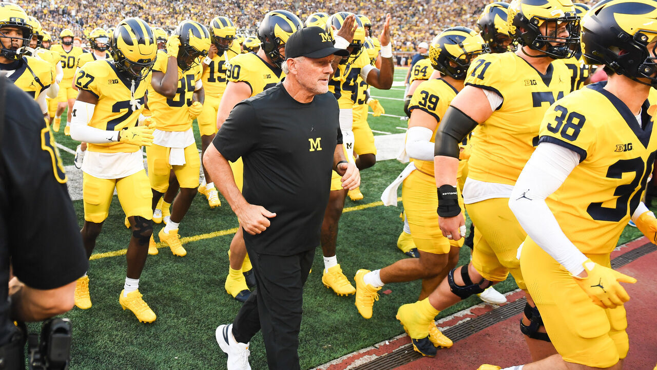 ANN ARBOR, MICHIGAN - SEPTEMBER 05: Head Football Coach Kyle Whittingham of the Michigan Wolverines runs off the field with his team before a college football game against the Western Michigan Broncos at Michigan Stadium on September 05, 2026 in Ann Arbor, Michigan.