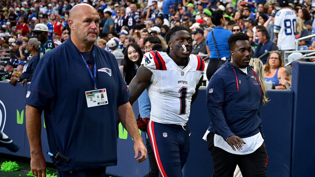 SEATTLE, WASHINGTON - SEPTEMBER 09: A.J. Brown #1 of the New England Patriots is assisted off the field after being injured in a play against the Seattle Seahawks during the third quarter in the game at Lumen Field on September 09, 2026 in Seattle, Washington.