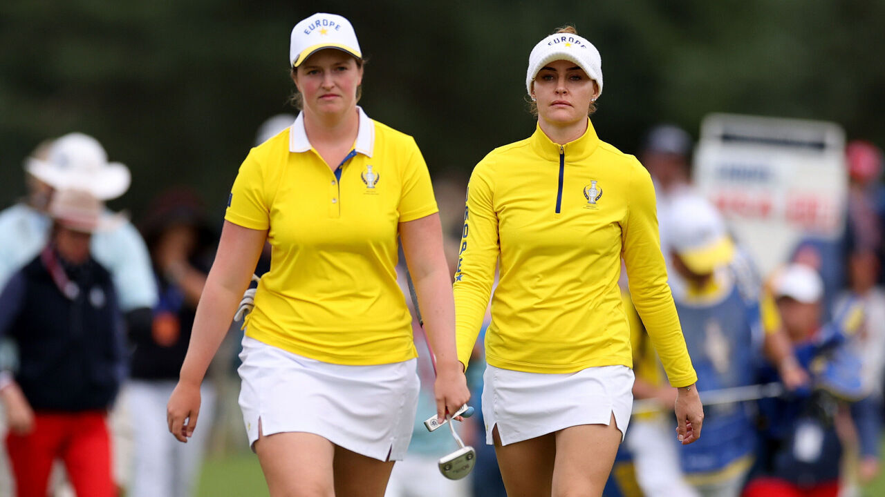 CROMVOIRT, NETHERLANDS - SEPTEMBER 12: Charley Hull of Team Europe and Lottie Woad of Team Europe walk down the 18th fairway during the Saturday afternoon four-ball matches of the Solheim Cup 2026 at Bernardus Golf on September 12, 2026 in Cromvoirt, Netherlands.