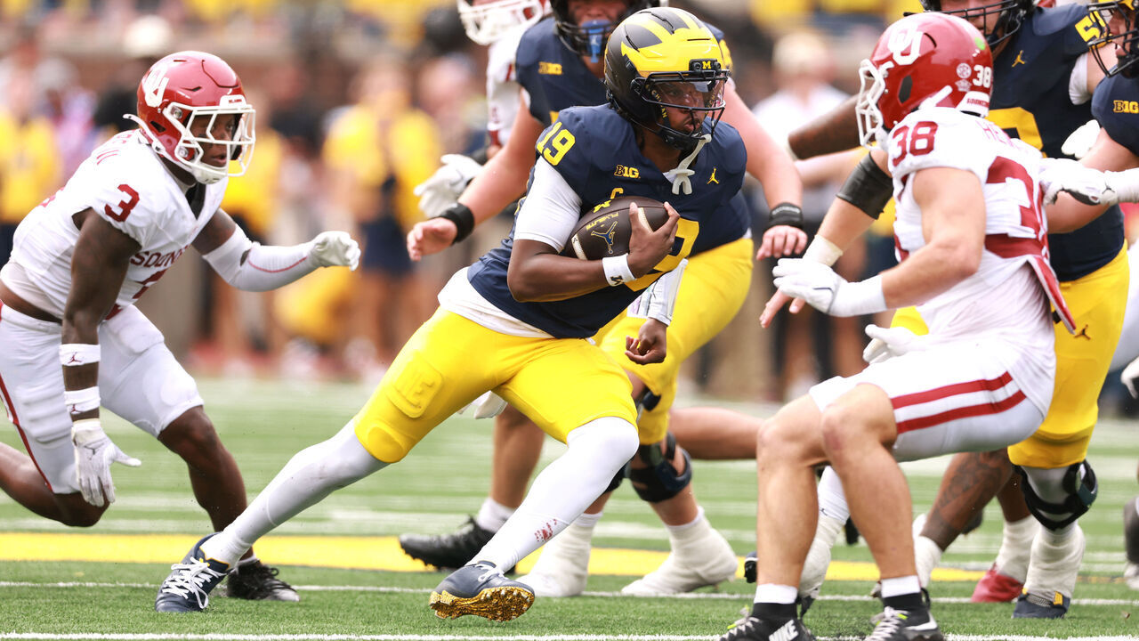ANN ARBOR, MICHIGAN - SEPTEMBER 12: Bryce Underwood #19 of the Michigan Wolverines runs past Owen Heinecke #38 of the Oklahoma Sooners for a first quarter touchdown at Michigan Stadium on September 12, 2026 in Ann Arbor, Michigan.