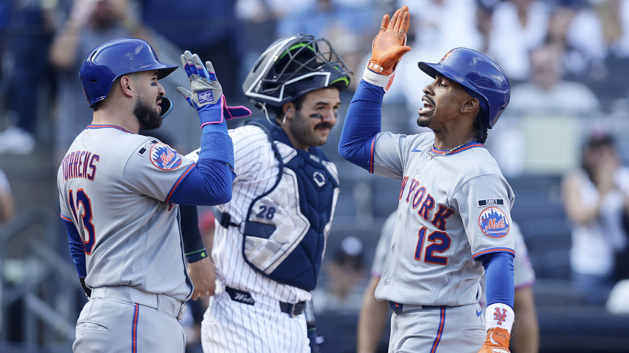 NEW YORK, NEW YORK - SEPTEMBER 12: Francisco Lindor #12 of the New York Mets celebrates his eighth inning grand slam home run with teammate Luis Torrens #13 as Austin Wells #28 of the New York Yankees looks on at Yankee Stadium on September 12, 2026 in New York City.