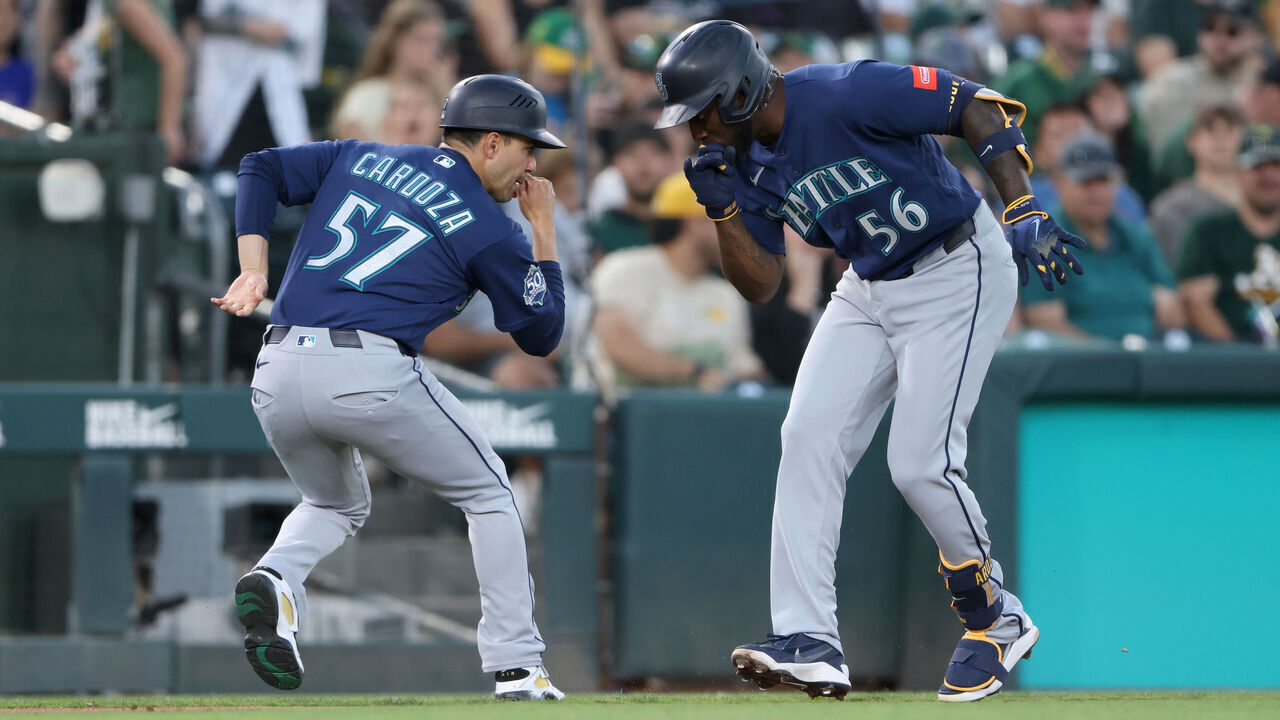 SACRAMENTO, CALIFORNIA - SEPTEMBER 12: Randy Arozarena #56 of the Seattle Mariners celebrates with third base coach Carlos Cardoza #57 of the Seattle Mariners after hitting a three-run home run during the top of the second inning at Sutter Health Park on September 12, 2026 in Sacramento, California.