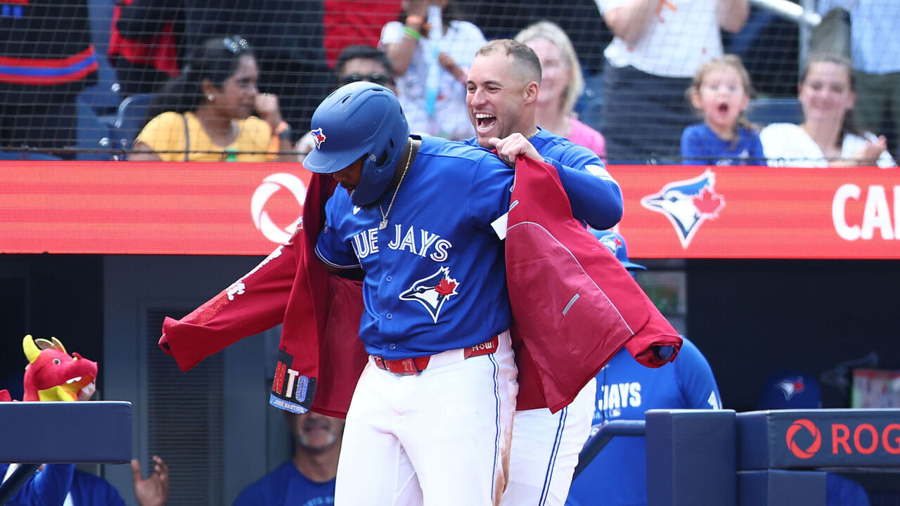 TORONTO, ON - SEPTEMBER 13: Vladimir Guerrero Jr. #27 of the Toronto Blue Jays receives the Blue Jays Home Run Jacket from George Springer #4 after hitting a solo home run in the fifth inning during a game against the Baltimore Orioles at Rogers Centre on September 13, 2026 in Toronto, Ontario, Canada.