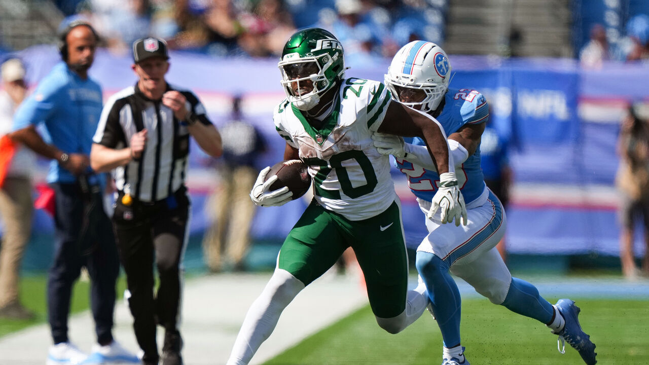 NASHVILLE, TENNESSEE - SEPTEMBER 13: Breece Hall #20 of the New York Jets runs the ball against Kevin Winston Jr. #23 of the Tennessee Titans during the fourth quarter of the game at Nissan Stadium on September 13, 2026 in Nashville, Tennessee.