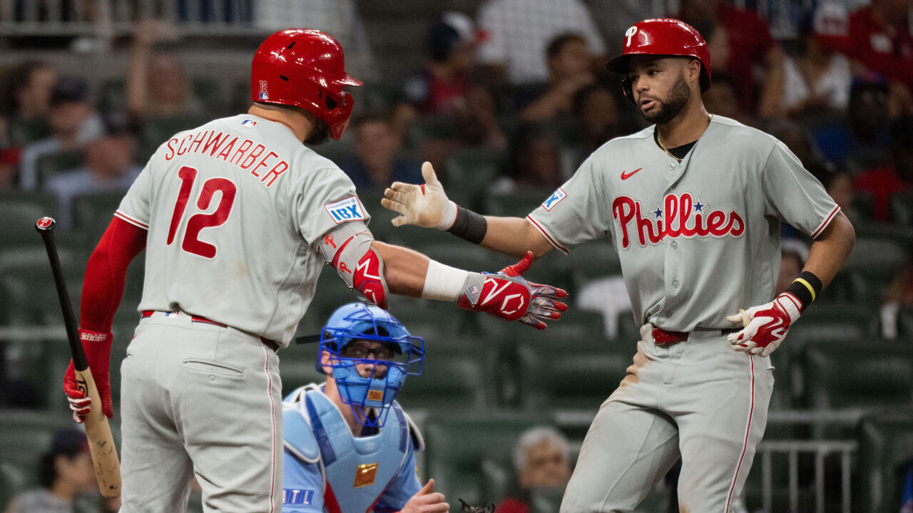 ATLANTA, GEORGIA - SEPTEMBER 12: Justin Crawford #2 of the Philadelphia Phillies (right) celebrates with Kyle Schwarber #12 after hitting a solo home run in the eighth inning of a game against the Atlanta Braves at Truist Park on September 12, 2026 in Atlanta, Georgia.
