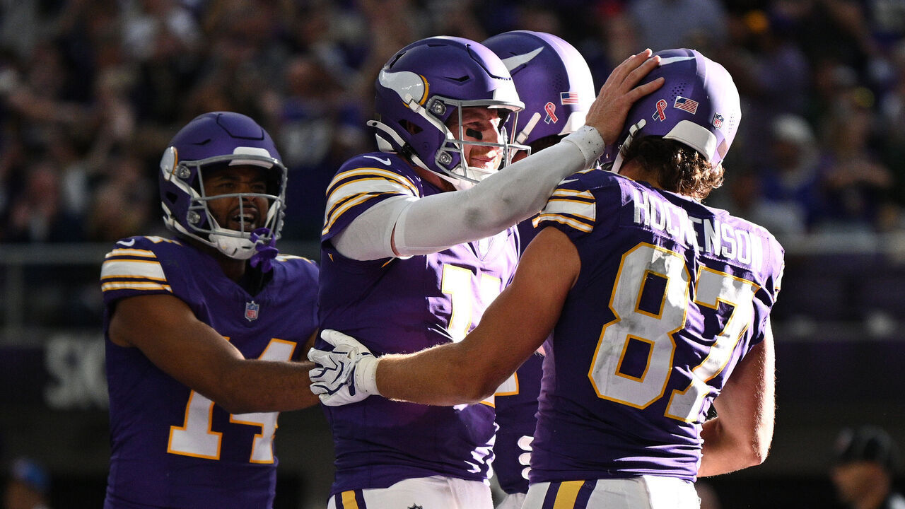 MINNEAPOLIS, MINNESOTA - SEPTEMBER 13: Carson Wentz #11 and T.J. Hockenson #87 of the Minnesota Vikings celebrate after Hockenson's receiving touchdown against the Green Bay Packers in the third quarter of a game at U.S. Bank Stadium on September 13, 2026 in Minneapolis, Minnesota.