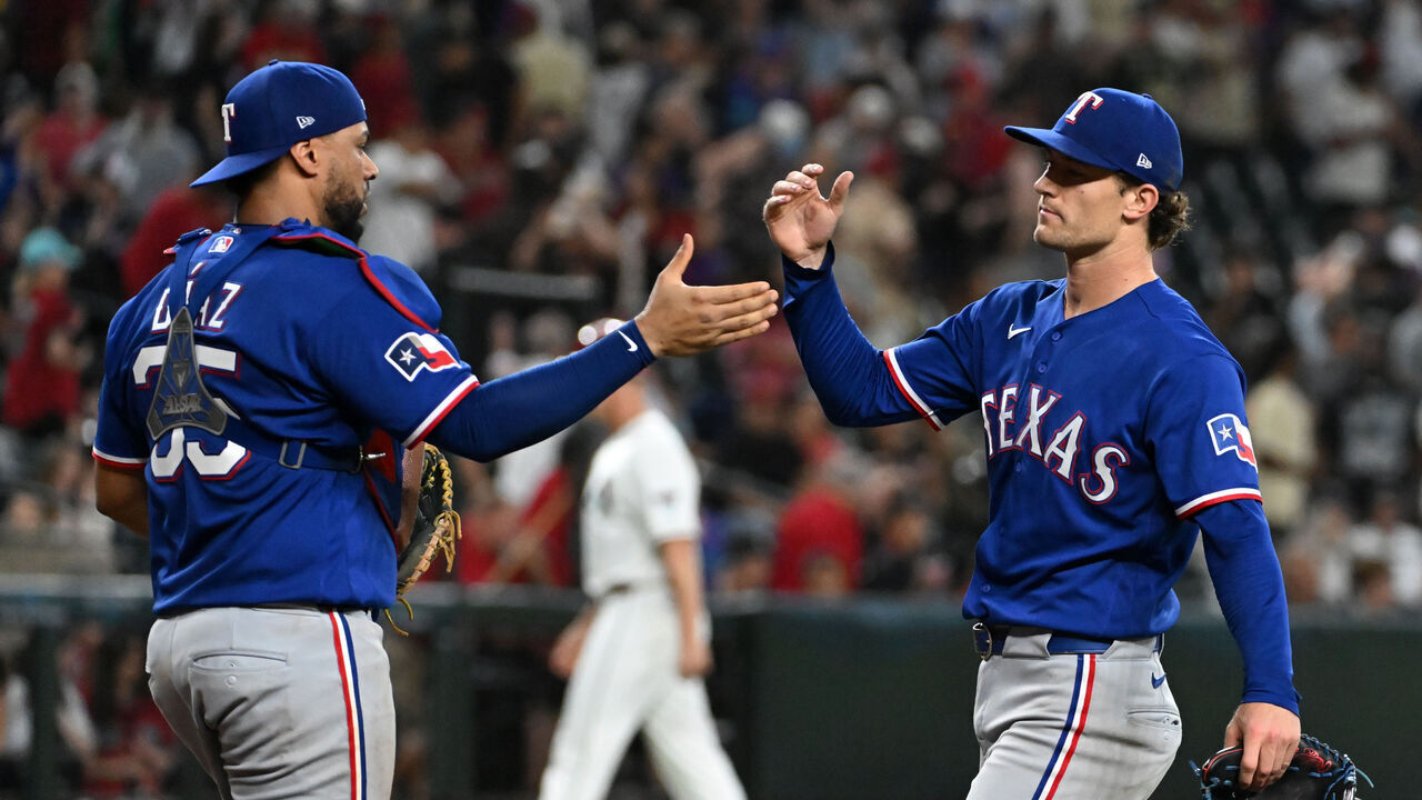 PHOENIX, ARIZONA - SEPTEMBER 13: Jacob Latz #67 and Elias Diaz #35 of the Texas Rangers celebrate a 7-6 win against the Arizona Diamondbacks at Chase Field on September 13, 2026 in Phoenix, Arizona.