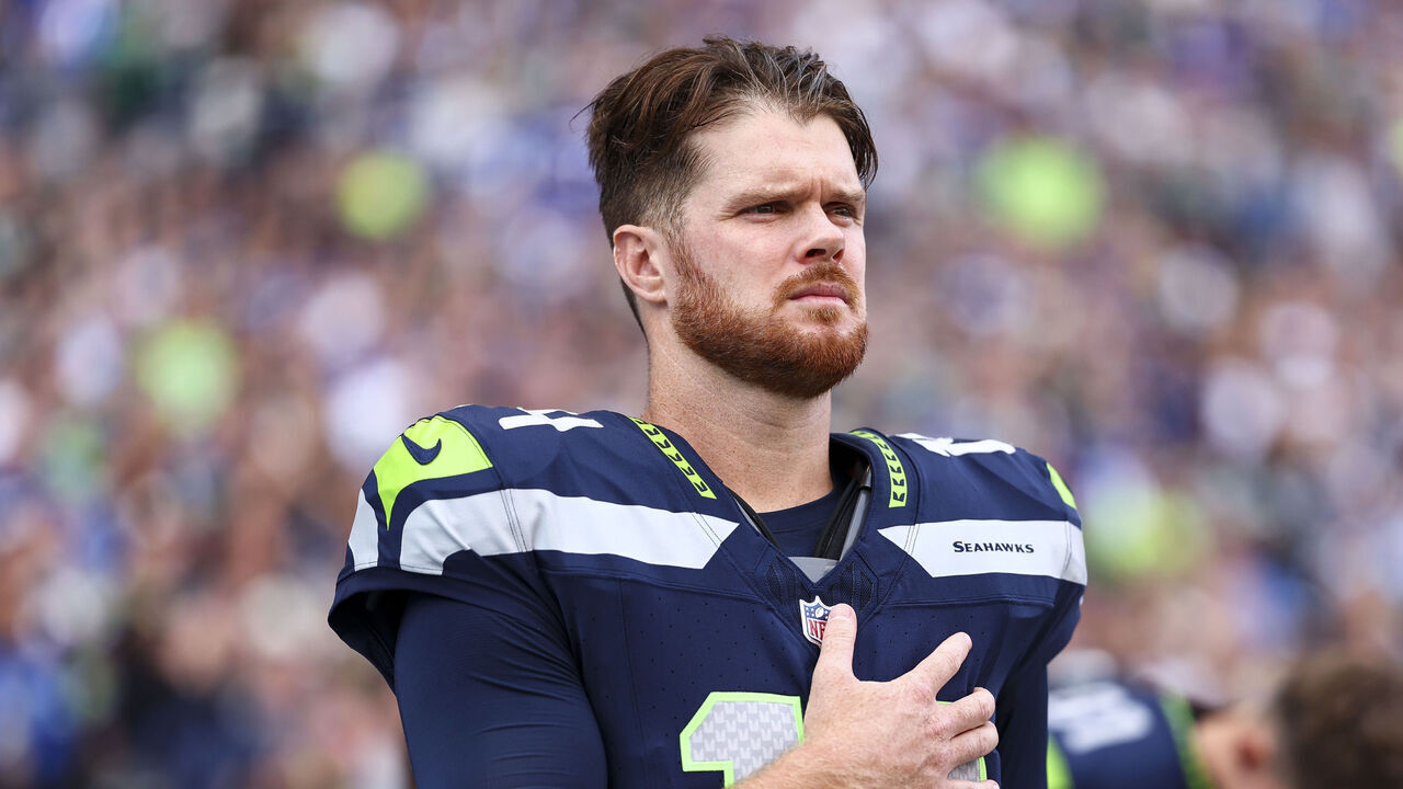 SEATTLE, WASHINGTON - SEPTEMBER 9: Sam Darnold #14 of the Seattle Seahawks stands on the sidelines during the national anthem prior to an NFL football game against the New England Patriots at Lumen Field on September 9, 2026 in Seattle, Washington.