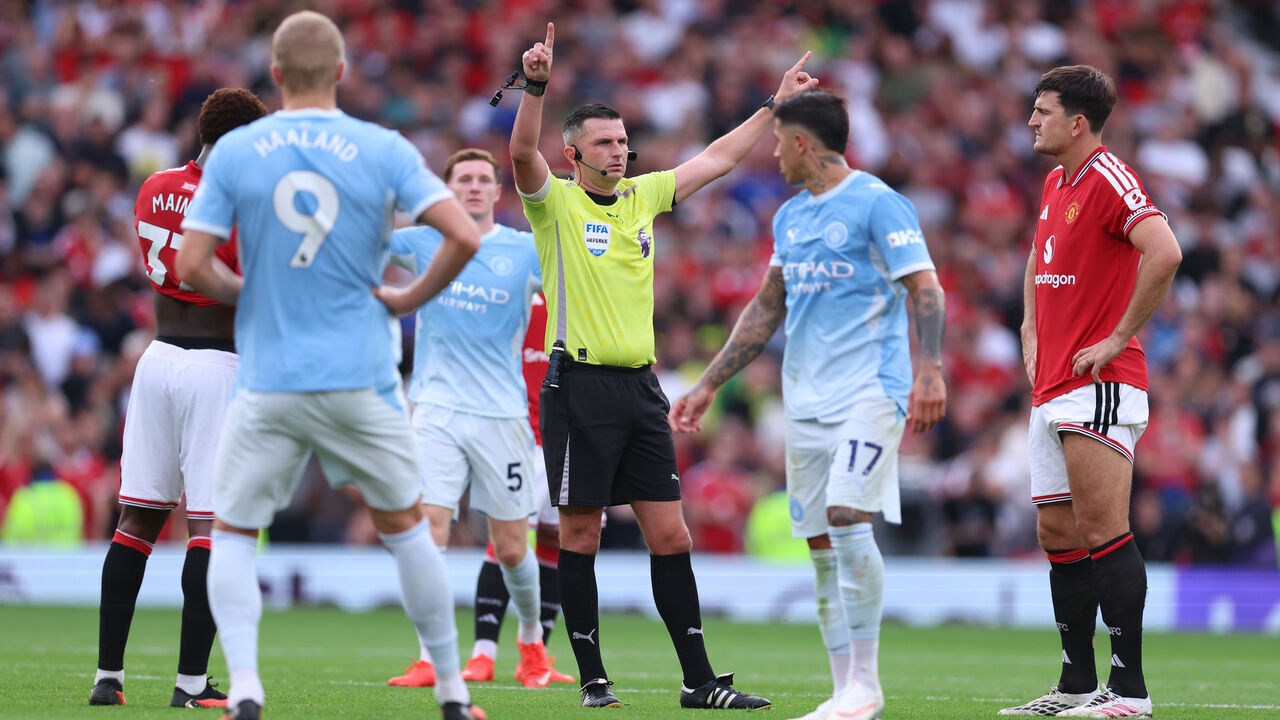 MANCHESTER, ENGLAND - SEPTEMBER 13: Players wait for Referee Michael Oliver to reveal the VAR decision for the goal scored by Erling Haaland of Manchester City during the Premier League 2026/27 match between Manchester United and Manchester City at Old Trafford on September 13, 2026 in Manchester, England.