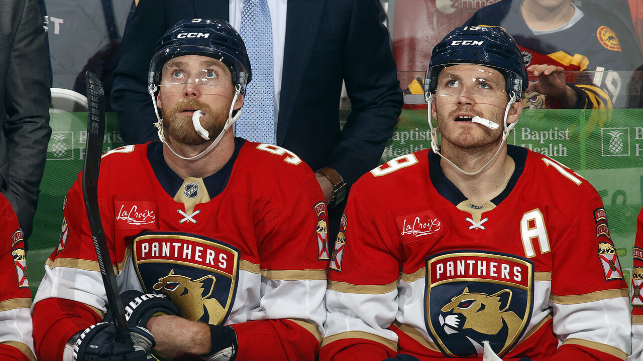 SUNRISE, FLORIDA - MARCH 24: Sam Bennett #9 and Matthew Tkachuk #19 of the Florida Panthers chew on mouth guards between shifts against the Seattle Kraken at the Amerant Bank Arena on March 24, 2026 in Sunrise, Florida.