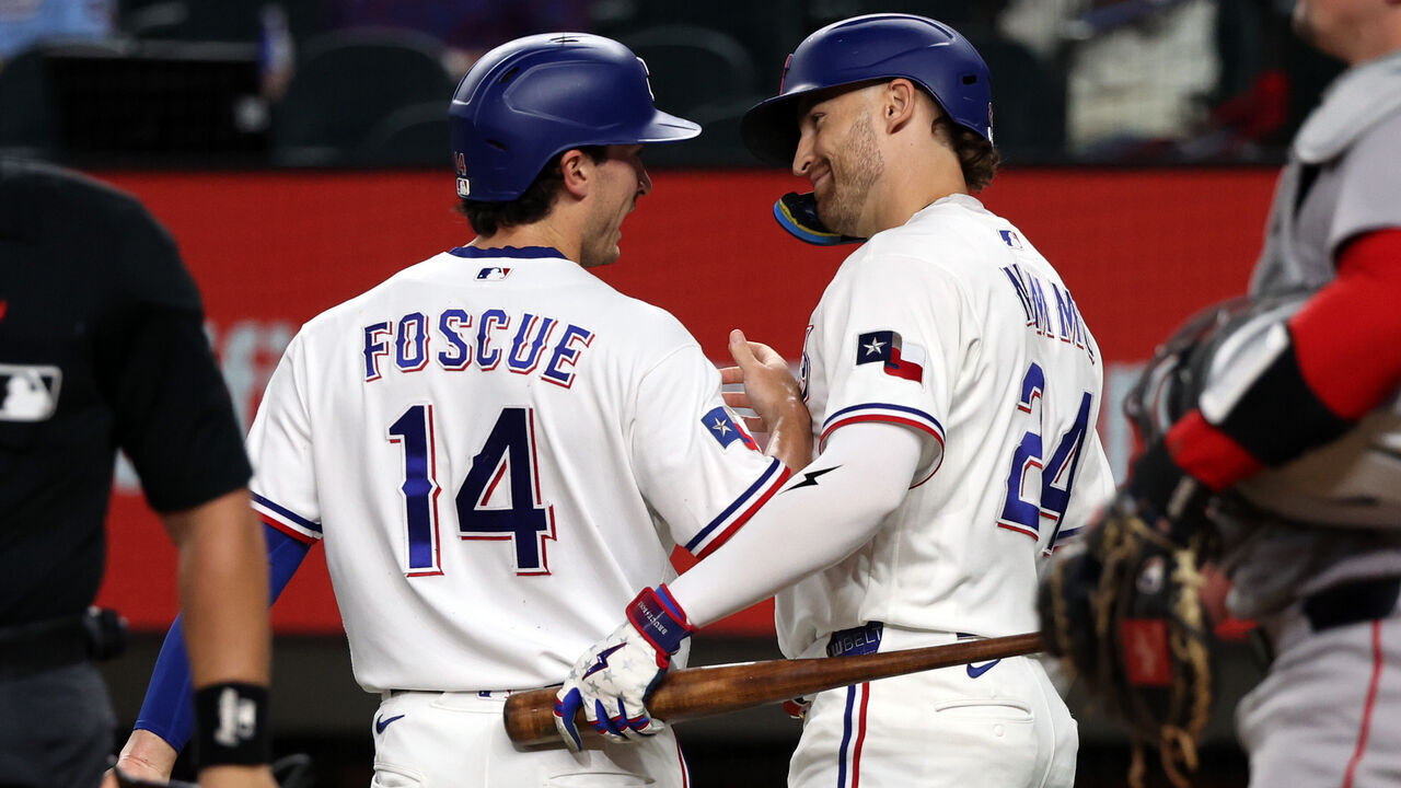 ARLINGTON, TEXAS - SEPTEMBER 16: Justin Foscue #14 of the Texas Rangers celebrates with Brandon Nimmo #24 after scoring in the first inning against the Boston Red Sox at Globe Life Field on September 16, 2026 in Arlington, Texas.