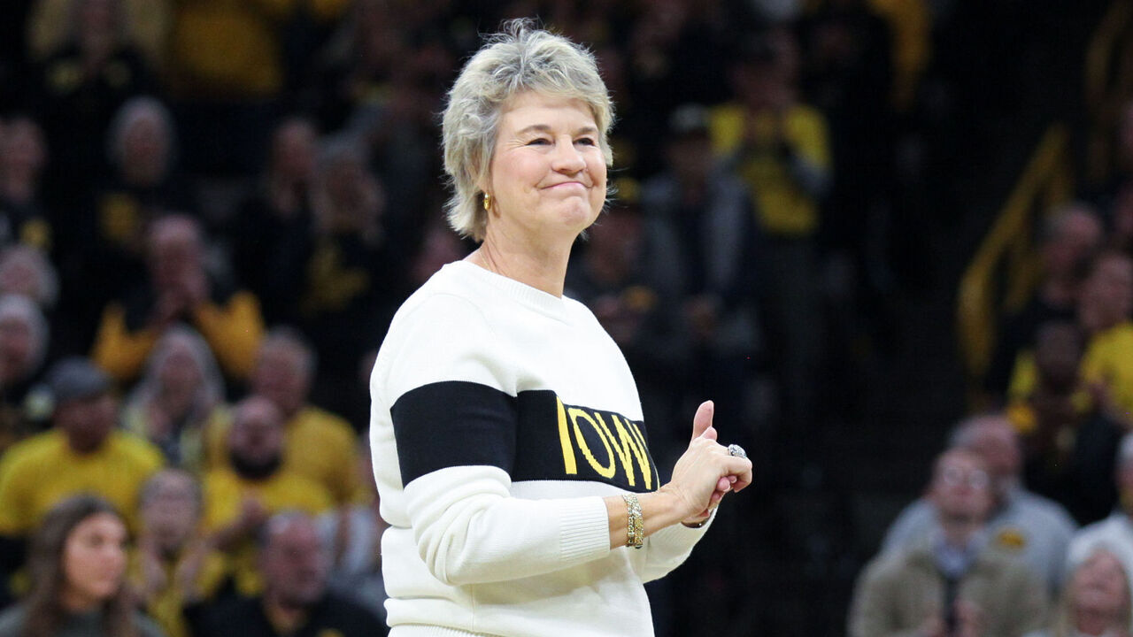 IOWA CITY, IOWA- JANUARY 5: Former Iowa Hawkeyes head coach Lisa Bluder acknowledges the crowd during a presentation honoring her during halftime of the match-up against the Maryland Terrapins, at Carver-Hawkeye Arena on January 5, 2025 in Iowa City, Iowa.