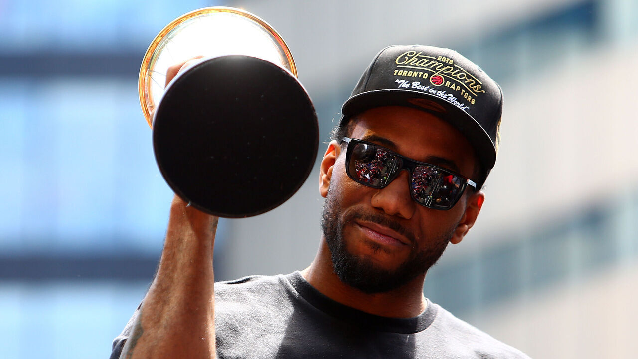 TORONTO, ON - JUNE 17: Kawhi Leonard #2 of the Toronto Raptors holds the MVP trophy during the Toronto Raptors Victory Parade on June 17, 2019 in Toronto, Canada. The Toronto Raptors beat the Golden State Warriors 4-2 to win the 2019 NBA Finals.