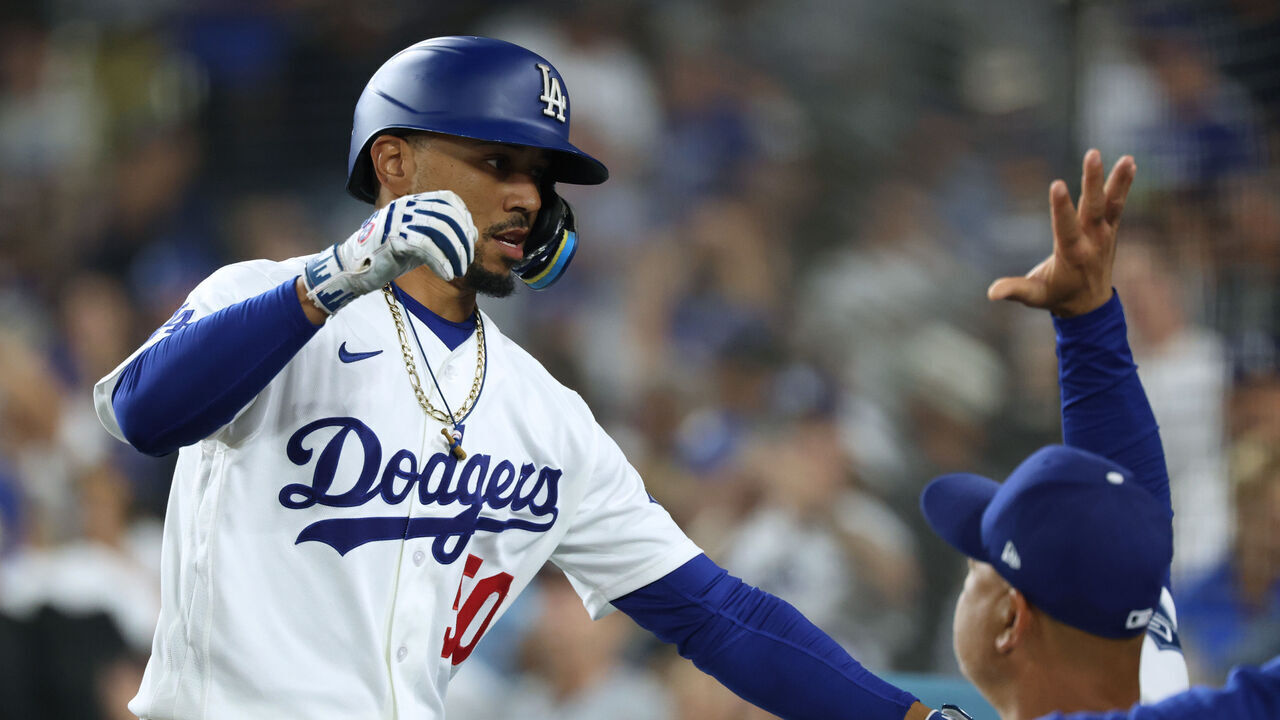 LOS ANGELES, CALIFORNIA - SEPTEMBER 18: Mookie Betts #50 of the Los Angeles Dodgers celebrates a solo home run with Dave Roberts #30, to take a 1-0 lead over the San Francisco Giants, during the first inning at Dodger Stadium on September 18, 2026 in Los Angeles, California.