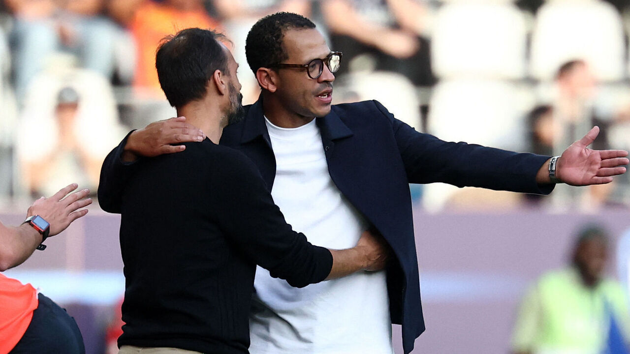 Strasbourg's Portuguese headcoach Hugo Oliveira shows support to Paris FC's English head coach Liam Rosenior (R) during the French L1 football match between Paris FC and RC Strasbourg at Stade Jean Bouin in Paris on September 19, 2026. A message has been issued to Strasbourg's supporters asking them to stop singing discriminatory chants directed at the Rosenior.