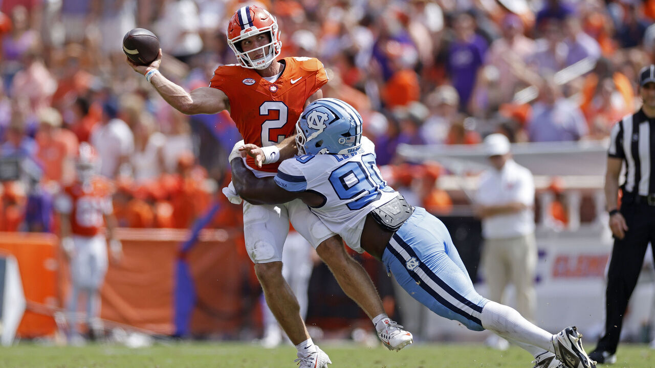 CLEMSON, SC - SEPTEMBER 19: Tait Reynolds (2) of the Clemson Tigers passes the ball while under pressure from Xavier Lewis (90) of the North Carolina Tar Heels during the college football game on September 19, 2026 at Memorial Stadium in Clemson, South Carolina.