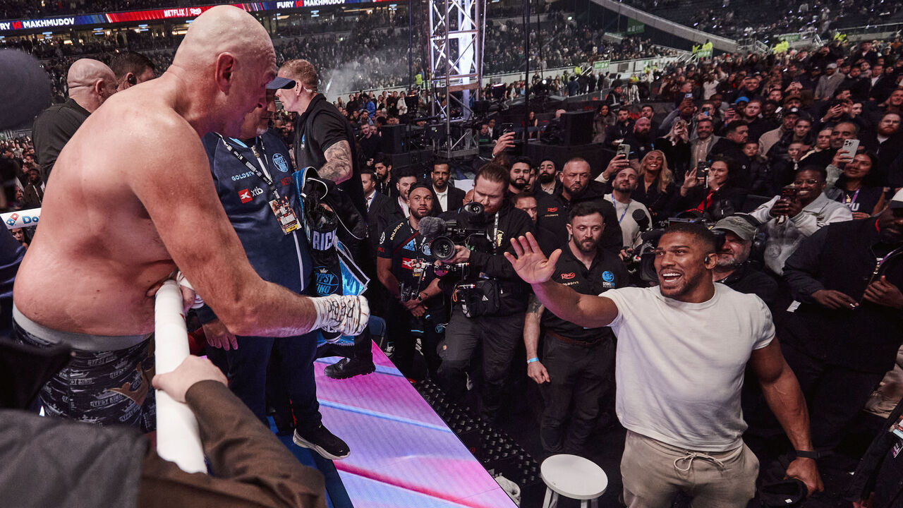 LONDON, ENGLAND - APRIL 11: Tyson Fury exchanges words with Anthony Joshua after his fight at Tottenham Hotspur Stadium on April 11, 2026 in London, England.
