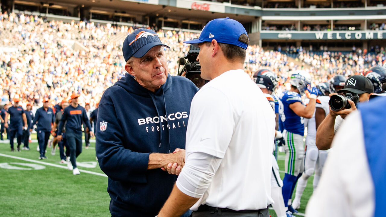 SEATTLE, WASHINGTON - SEPTEMBER 08: Head coach Sean Payton of the Denver Broncos shakes hands with Head coach Mike Macdonald of the Seattle Seahawks after the game at Lumen Field on September 08, 2024 in Seattle, Washington.