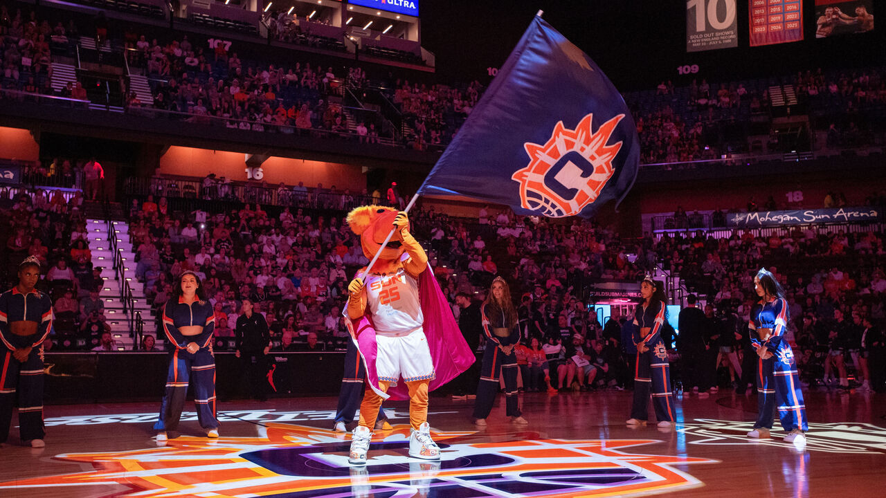 UNCASVILLE, CT - AUGUST 15: Blaze, the Connecticut Sun mascot, waves a Connecticut Sun logo flag before the WNBA game between the New York Liberty and the Connecticut Sun on August 15, 2026 at Mohegan Sun Arena in Uncasville, CT.
