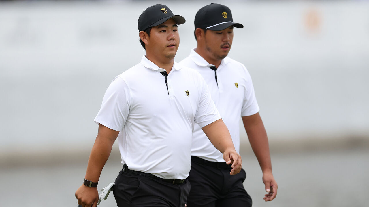 MEDINAH, ILLINOIS - SEPTEMBER 24: Si Woo Kim of South Korea and the International Team and Tom Kim of South Korea and the International Team walkon the 16th green during Thursday's Four-ball matches on day one of the Presidents Cup 2026 at Medinah Country Club on September 24, 2026 in Medinah, Illinois.