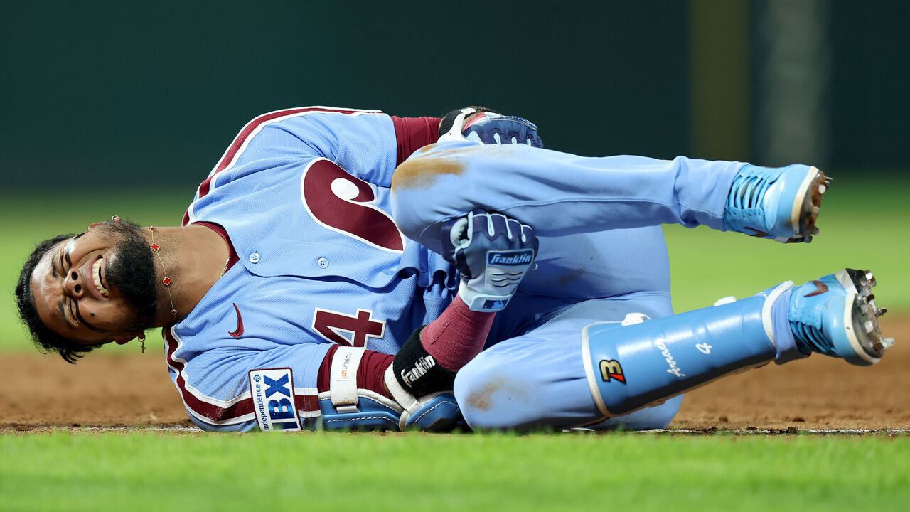 PHILADELPHIA, PENNSYLVANIA - SEPTEMBER 24: Luis Arraez #4 of the Philadelphia Phillies reacts after an injury at first base in the sixth inning during a game against the Milwaukee Brewers at Citizens Bank Park on September 24, 2026 in Philadelphia, Pennsylvania.