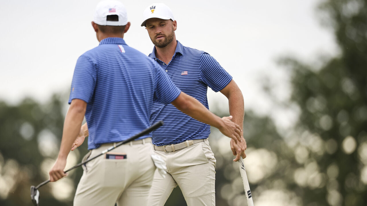 CHICAGO, ILLINOIS - SEPTEMBER 24: Wyndham Clark of the U.S. Team reacts with Collin Morikawa of the U.S. Team after sinking his putt on the 15th green during Day One of the Presidents Cup at Medinah Country Club Course No. 3 on September 24, 2026 in Chicago, Illinois.