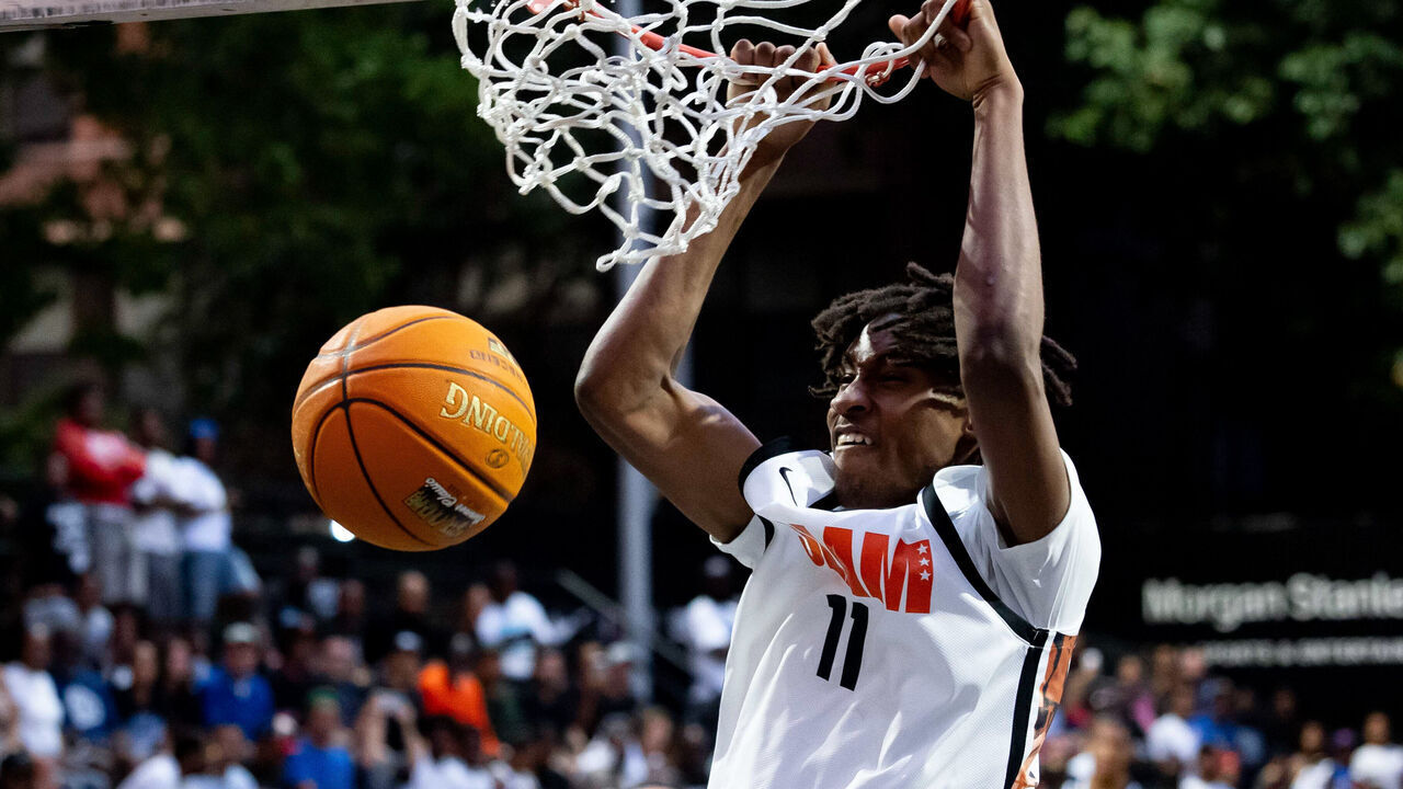 NEW YORK, NEW YORK - AUGUST 17: Class of 2027 high school basketball recruit Moussa Kamissoko #11 dunks during the SLAM Summer Classic at Rucker Park on August 17, 2026 in New York City.