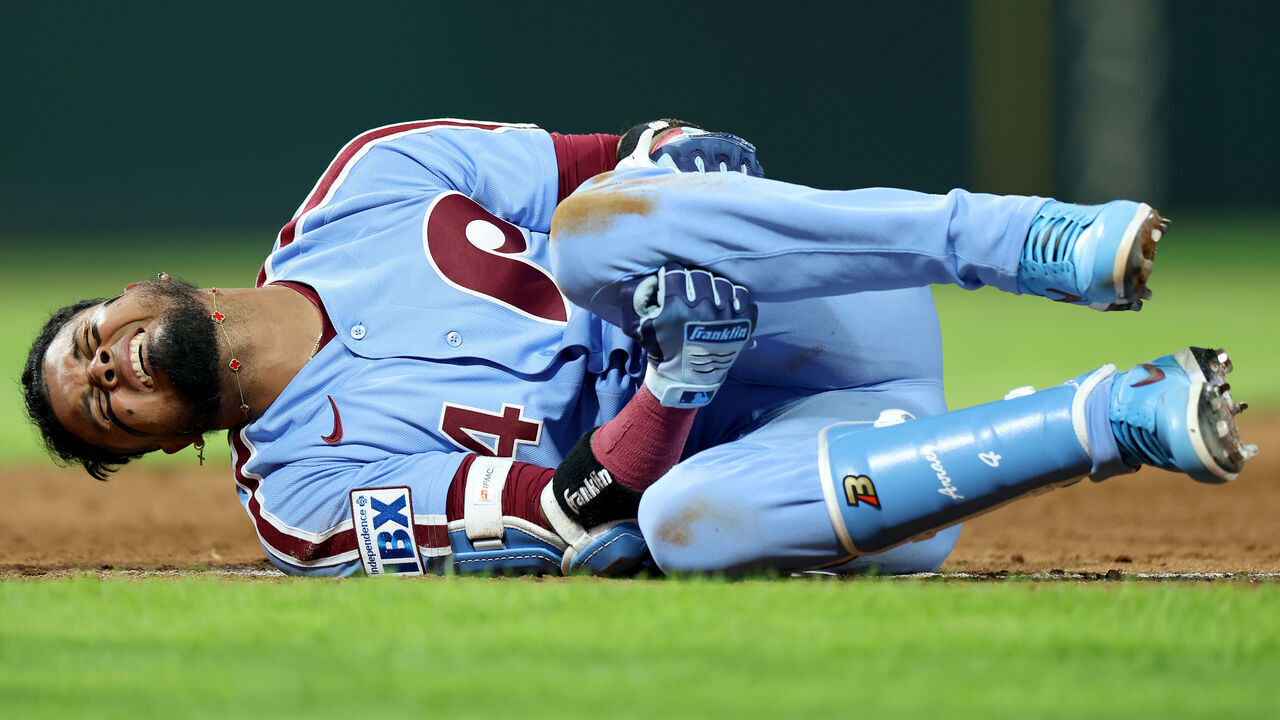 PHILADELPHIA, PENNSYLVANIA - SEPTEMBER 24: Luis Arraez #4 of the Philadelphia Phillies reacts after an injury at first base in the sixth inning during a game against the Milwaukee Brewers at Citizens Bank Park on September 24, 2026 in Philadelphia, Pennsylvania.