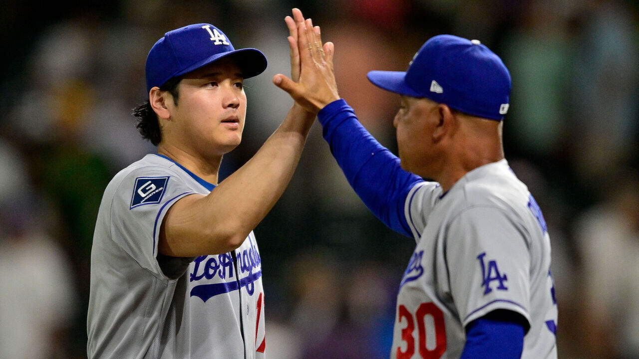 DENVER, CO - AUGUST 18: Los Angeles Dodgers designated hitter Shohei Ohtani (17) celebrates the win with Manager Dave Roberts (30) after a game between the Los Angeles Dodgers and the Colorado Rockies at Coors Field on August 18, 2026 in Denver, Colorado.