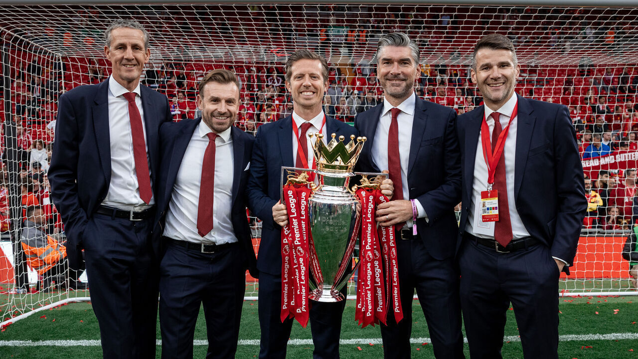 LIVERPOOL, ENGLAND - MAY 25: (THE SUN OUT, THE SUN ON SUNDAY OUT) Barry Hunter, Julian Ward, Michael Edwards, Richard Hughes and David Woodfine pose for a photograph with the Premier League trophy, as Liverpool are crowned the Champions of the Premier League for the 2024/25 Season, following Premier League match between Liverpool FC and Crystal Palace FC at Anfield on May 25, 2025 in Liverpool, England.