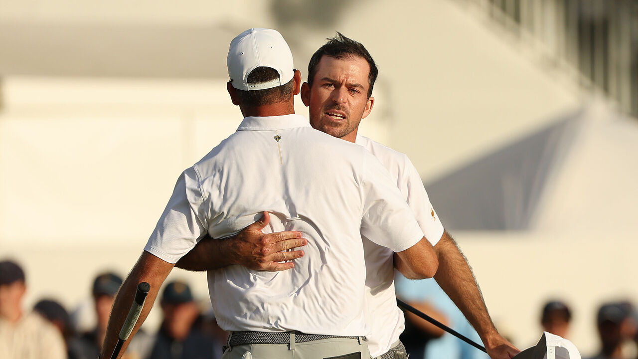 MEDINAH, ILLINOIS - SEPTEMBER 26: Corey Conners of Canada and the International Team reacts with Nick Taylor of Canada and the International Team on the 18th green during Saturday's Foursome matches on day three of the Presidents Cup 2026 at Medinah Country Club on September 26, 2026 in Medinah, Illinois.